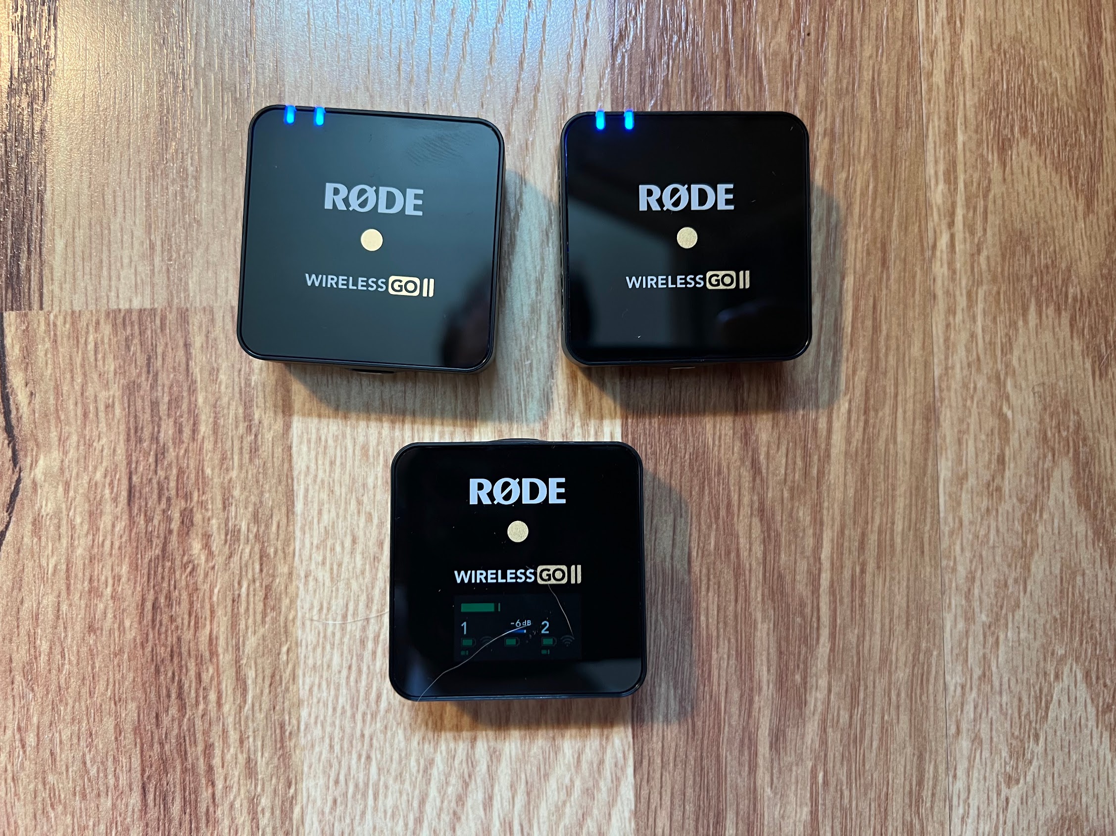 Two small lav microphones and their receiver.