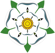This is the White Rose of York, a white heraldic rose, which is the symbol of the House of York. Traditionally the origins of the emblem are said to go back to Edmund of Langley in the 14th century, the first Duke of York and the founder of the House of York as a Cadet branch of the then ruling House of Plantagenet.[24] The actual symbolism behind the rose has religious connotations as it represents the Virgin Mary, who was often called the Mystical Rose of Heaven.[24][25]