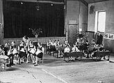 Child evacuees from London receive their school lessons in a village hall in Ffarmers, Carmarthenshire (1940)